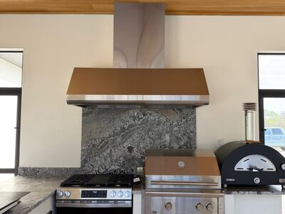 Kitchen with stainless steel appliances and grey marble counter tops